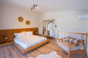 a bedroom with a bed and a chair and a clock at NİSH VADİ SAPANCa in Sapanca +101 photos