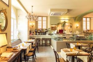 a restaurant with tables and chairs and a counter at Hotel Royal Victoria, by R Collection Hotels in Varenna