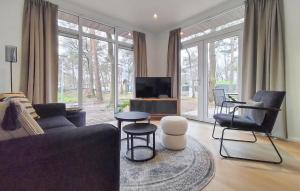 a living room with a couch and chairs and a tv at 2 Bedroom Lovely Home In Hellendoorn in Hellendoorn