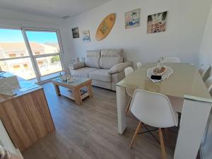 a living room with a table and a couch at Beach House in Puerto de Mazarrón