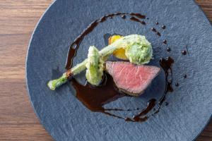 a plate of food with meat and vegetables on it at オーベルジュ南アルプス in Minami Alps