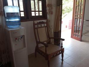 a water cooler and a chair with a water bottle at Kiyara Holiday Villa in Ambalangoda