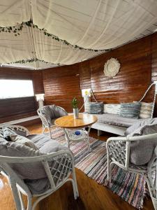 a living room with a couch and chairs and a table at Vila Viorica in Mamaia Sat/Năvodari