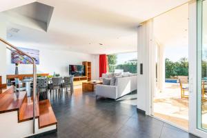 a living room with a couch and a table at Villa Julianne by Villa Plus in Cala en Blanes