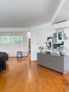 a living room with a table and a couch at Great V4 Villa with Private Salt Pool in Quinta do Anjo