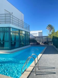 a swimming pool with a stair in front of a building at Great V4 Villa with Private Salt Pool in Quinta do Anjo