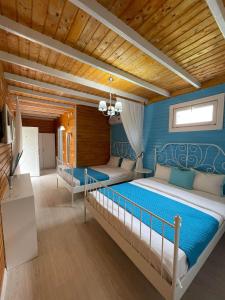 a bedroom with two beds and a wooden ceiling at Vila Viorica in Mamaia Sat/Năvodari