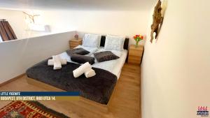a bedroom with a bed with two pillows at Little Americas National Parks Apartments in Budapest +31 photos