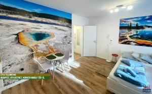 a living room with a large painting on the wall at Little Americas National Parks Apartments in Budapest