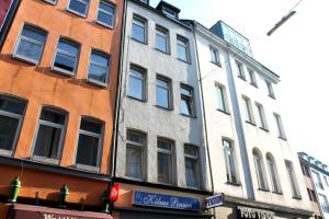 a tall building on a city street next to another building at Kölner Pension in Cologne