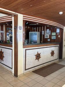 a lobby with a counter with a bar in a building at Hotel Veleiro in Florianópolis