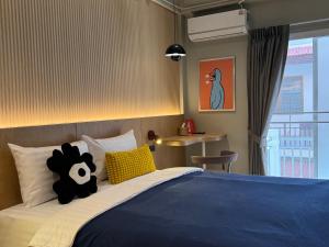 Llit o llits en una habitació de LAZYDAY IN NIMMAN