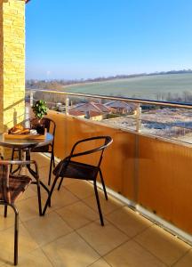 a balcony with a table and chairs and a view at Grand Apartman - 5 Star Luxury Podhajska Apartman in Podhájska