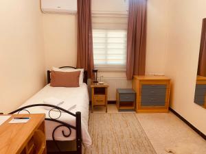 Postel nebo postele na pokoji v ubytování Baytna Hotel