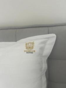 a white napkin with a logo on it at Tudisi Loft Room in Dubrovnik