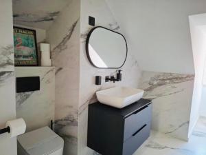 a bathroom with a sink and a mirror at Tudisi Loft Room in Dubrovnik
