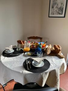 a table with a white table cloth with food on it at Les 9 Hirondelles in Charrin
