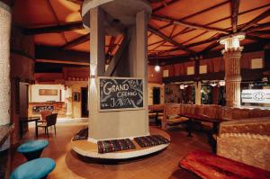 a restaurant with a pillar with a sign on it at Java Boutique Hotel in Lushoto