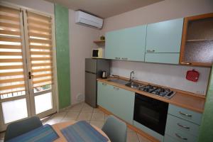 a kitchen with a sink and a stove top oven at Diana's home in Empoli