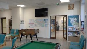 a room with a pool table and a tv at Auberge de Jeunesse HI Cherbourg in Cherbourg en Cotentin +9 photos