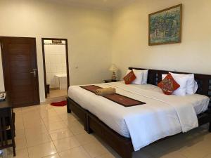 Postel nebo postele na pokoji v ubytování Brata Inn Ubud
