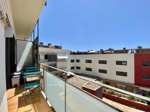 a balcony with a view of a building at LLOGUER30 El Far, swimming pool and parking in Sant Feliu de Guixols