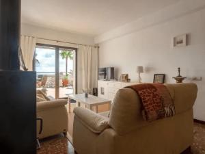 a living room with a couch and a table at Atico la piramide en primera 1º línea de mar in Vinarós