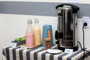 a table with two bottles and a blender on it at Hotel Los Ángeles in Mar del Plata
