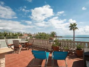 a patio with chairs and tables overlooking the ocean at Atico la piramide en primera 1º línea de mar in Vinarós
