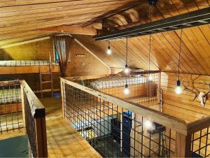 a large room with two cages in a building at Chalet de la Folie in Martelange