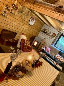 a room with a table and a clock on the wall at Chalet de la Folie in Martelange +23 photos