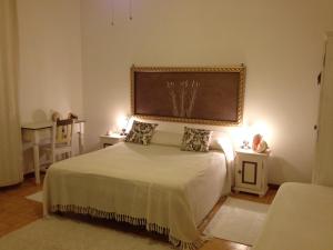 a bedroom with a bed with a large painting on the wall at Stella di Mare in La Maddalena +10 photos