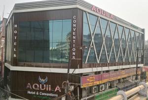 a building with a sign on the side of it at Aquila Hotel and Convention by The Nexus in Patna