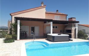 a villa with a swimming pool in front of a house at Villa Roza Murter in Šibenik