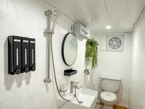 a bathroom with a toilet and a sink and a mirror at Doors Seongsu in Seoul