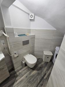 a small bathroom with a toilet and a sink at Beach Apartment A in Nea Karvali +56 photos