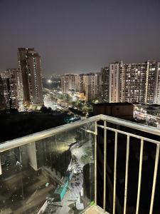 a view of a city at night with buildings at Golden palace studio in Noida