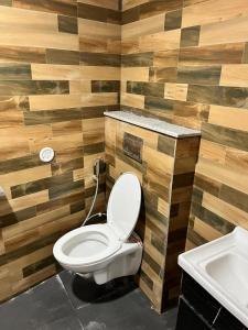 a bathroom with a toilet and a sink at Golden palace studio in Noida