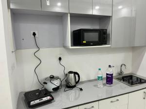 a kitchen with a counter top with a microwave at Golden palace studio in Noida