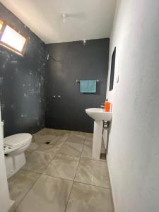 a bathroom with a toilet and a sink at Pensão CasaDanilo in Portela