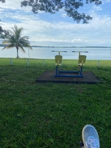 una persona in piedi sull'erba con tavolo e sedie di Rancho Coqueiros#Amor e Paz a Buritama