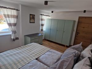 a bedroom with a bed and a cabinet and a window at Ferienmaisonette Purpurbuche in Reutte