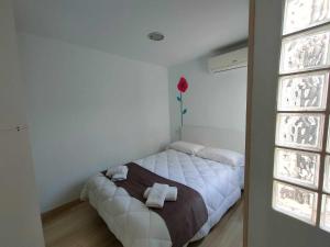 a bedroom with a bed with two towels on it at AMAIKA AH Rentals in Peniscola