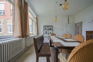a dining room with a table and chairs and a radiator at vakantiewoning Kloosterpad in Damme