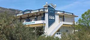 a building with a sign on the side of it at Blue Bay Beach Hotel in Koinyra