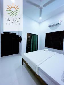 a bedroom with a bed and a sign on the wall at The Juzi House - private pool homestay in Kuala Terengganu +19 photos