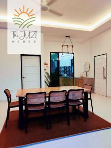 a dining room with a table and chairs at The Juzi House - private pool homestay in Kuala Terengganu