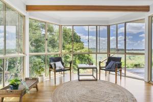 a living room with large windows and a large rug at The Avenue at Montville (House) in Montville