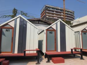 a row of buildings with benches in front of a building at ท่าบ่อนอร์ดิกเฮ้าส์ in Tha Bo