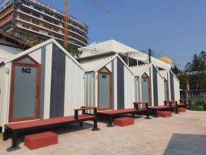 a row of portable toilets with red benches at ท่าบ่อนอร์ดิกเฮ้าส์ in Tha Bo